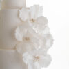 Side detail view of hand-crafted sugar flowers in ivory, on luxury customisable wedding cake, Chic Flowers, by Decorum Taste.