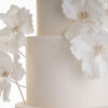 Contemporary hand-crafted sugar flowers on ivory luxury wedding cake by Decorum Taste.