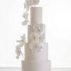 Luxury contemporary 4 tier, customisable wedding cake in ivory with delicate decorative piping and stems of hand-crafted sugar flowers, by Decorum Taste.