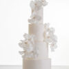 Luxury contemporary 4 tier, customisable wedding cake in ivory with delicate decorative piping and stems of hand-crafted sugar flowers, by Decorum Taste.