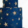 Details of luxury contemporary, customisable, celebration cake, Cosmos Star by Decorum Taste, in deep blue with flecks of edible gold and golden stars.