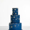 Three tier luxury contemporary, customisable, celebration cake, Cosmos Star by Decorum Taste, in deep blue with flecks of edible gold and golden stars.