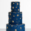 Three tier luxury contemporary, customisable, celebration cake, Cosmos Star by Decorum Taste, in deep blue with flecks of edible gold and golden stars.