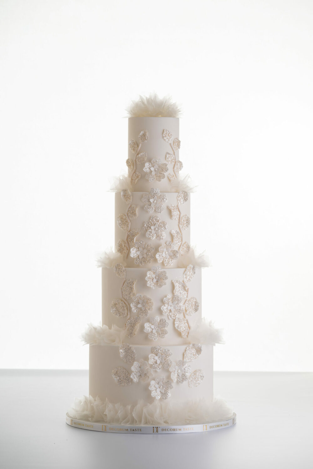 4 tier luxury customisable wedding cake, Daphne by Decorum Taste with sequin floral decorative detailing and rice paper ruffles.