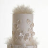 Top 2 tiers of luxury customisable wedding cake, Daphne, by Decorum Taste, with decorative details in edible glitter and delicate rice paper frills.