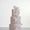 Three tier elegant contemporary customisable wedding cake, Eloise, in soft blush with large hand-crafted sugar flowers, by Decorum Taste.