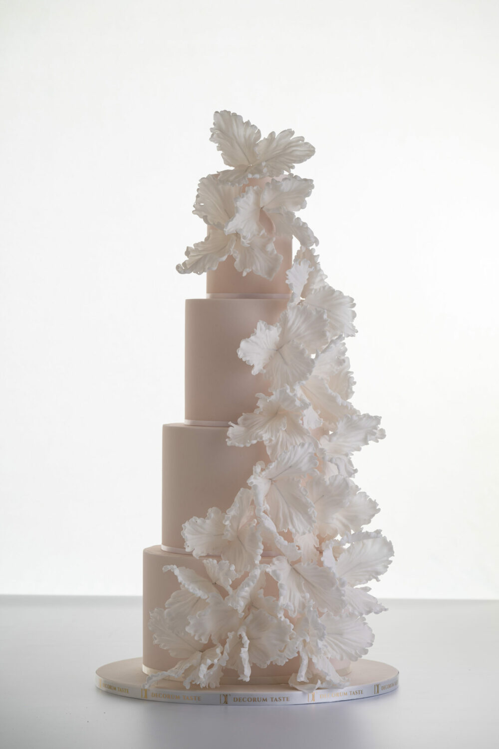 Four tier elegant contemporary customisable wedding cake, Eloise, in soft blush with large hand-crafted sugar flowers, by Decorum Taste.