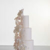 Four tier luxury contemporary, customisable, wedding cake, Floral Cascade by Decorum Taste, decorated with hand-crafted sugar roses, sweet peas and other petals in ivory and blush pink tones.