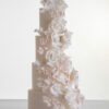 Four tier luxury contemporary, customisable, wedding cake, Floral Cascade by Decorum Taste, decorated with hand-crafted sugar roses, sweet peas and other petals in ivory and blush pink tones.