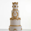 Four tier luxury customisable wedding cake in ivory with gold decorative details by Decorum Taste.