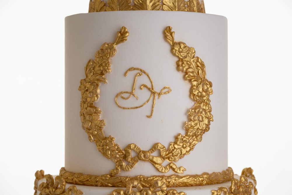 Detail of monogram in edible gold leaf on luxury customisable wedding cake, Lilibet, by Decorum Taste.