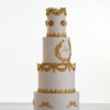 Four tier luxury customisable wedding cake in ivory with gold decorative details by Decorum Taste.