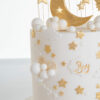 Detail of luxury contemporary, customisable, celebration cake, Moon Baby by Decorum Taste, in ivory with large golden moon, stars and clouds.