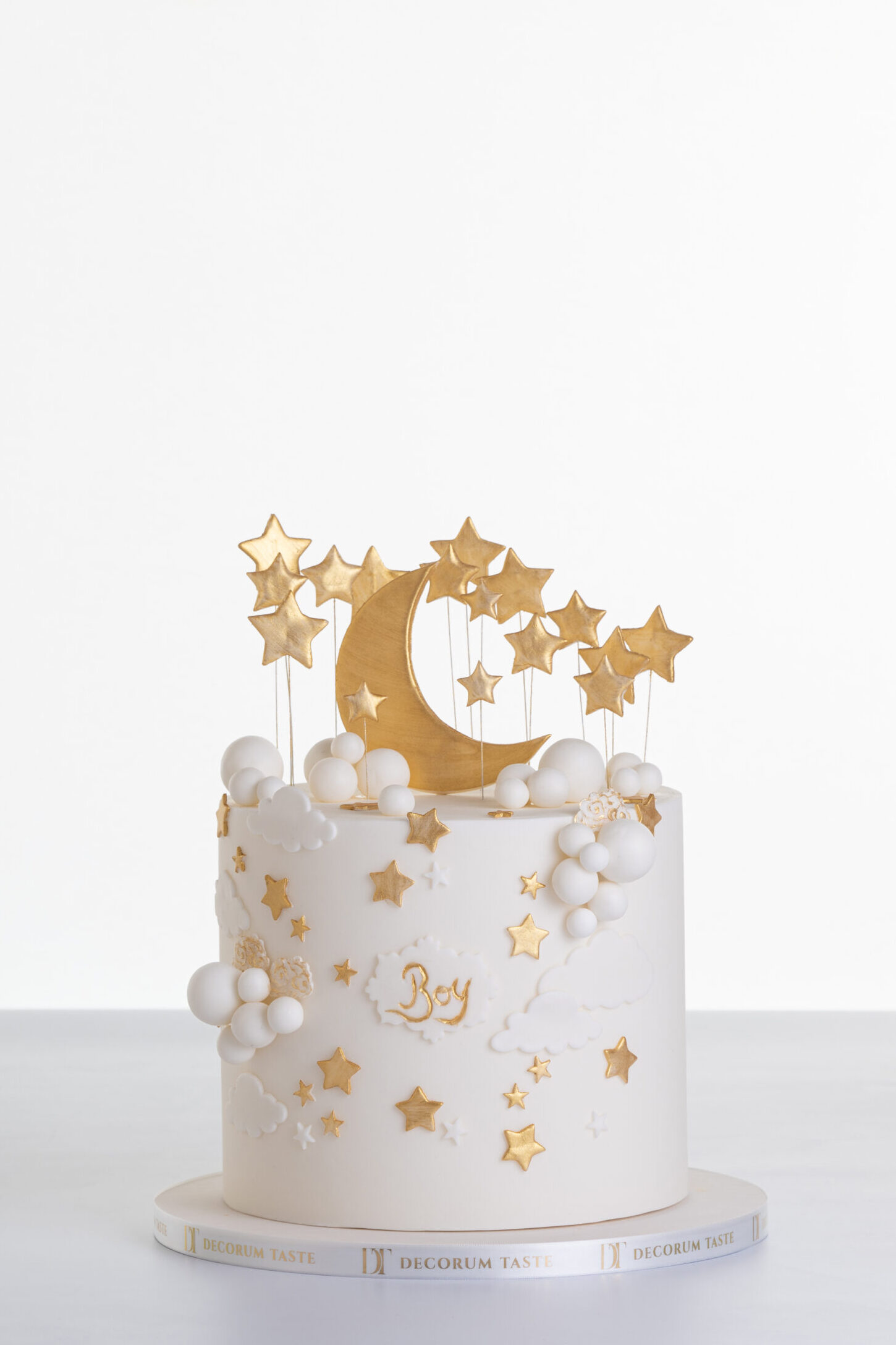 Single tier luxury contemporary, customisable, celebration cake, Moon Baby by Decorum Taste, in ivory with large golden moon, stars and clouds.