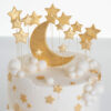 Top of luxury contemporary, customisable, celebration cake, Moon Baby by Decorum Taste, in ivory with large golden moon, stars and clouds.