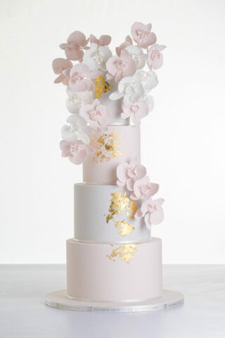 Four tier luxury contemporary, customisable, wedding cake, Orchid Heaven by Decorum Taste, with alternate tiers in blush pink and ivory, brushes of edible gold leaf and cascades of hand-crafted sugar orchids.