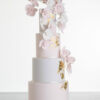 Four tier luxury contemporary, customisable, wedding cake, Orchid Heaven by Decorum Taste, with alternate tiers in blush pink and ivory, brushes of edible gold leaf and cascades of hand-crafted sugar orchids.