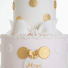 Details of luxury contemporary, customisable, celebration cake, Polka Mouse by Decorum Taste, with decorative edible gold leaf circle embellishments, a pretty floral trim and sugar paste bow.