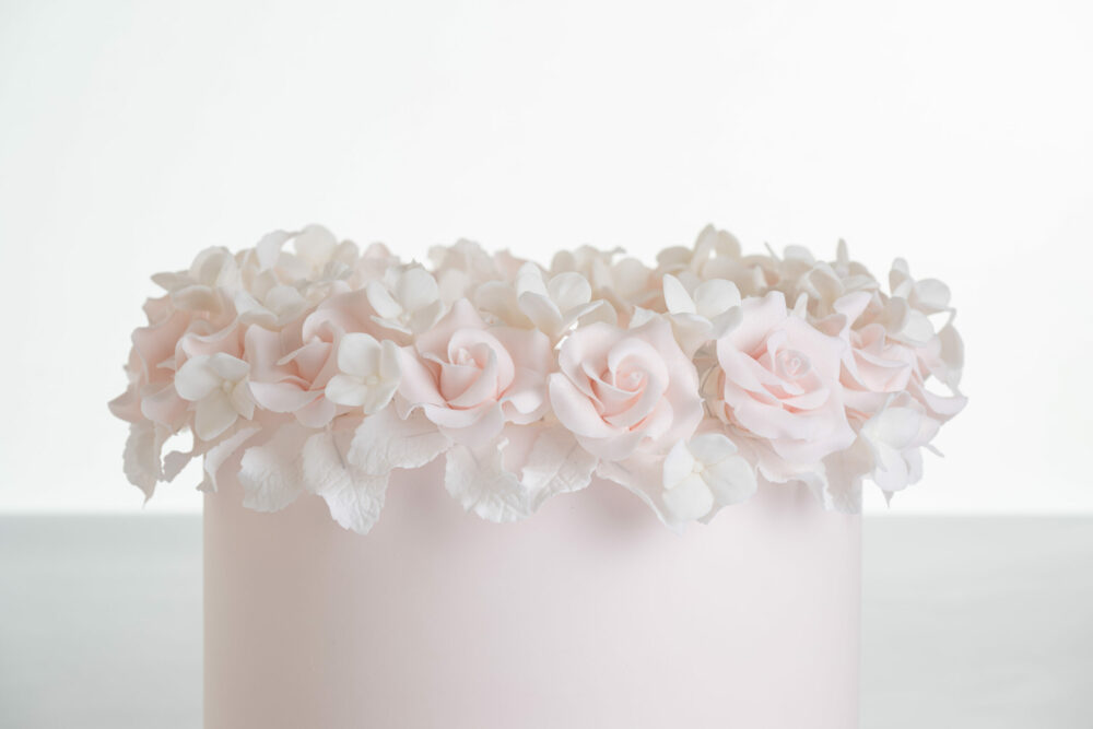 Single tier luxury contemporary, customisable, celebration cake, Ring of Roses by Decorum Taste, in blush pink with ring of hand-crafted sugar roses and petals at the top.