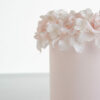 Detail of luxury contemporary, customisable, celebration cake, Ring of Roses by Decorum Taste, in blush pink with ring of hand-crafted sugar roses and petals at the top.