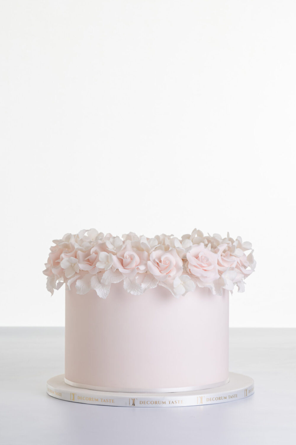 Single tier luxury contemporary, customisable, celebration cake, Ring of Roses by Decorum Taste, in blush pink with ring of hand-crafted sugar roses and petals at the top.