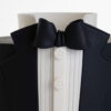 Detail of luxury contemporary, customisable, celebration cake, Tux Gent by Decorum Taste decorated in black the white of a formal shirt, tuxedo jacket and bow tie.