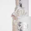 Top two tiers of luxury contemporary, customisable, wedding cake, Vintage Beauty by Decorum Taste with large hand-crafted sugar rose in ivory and brushed edible silver leaf.